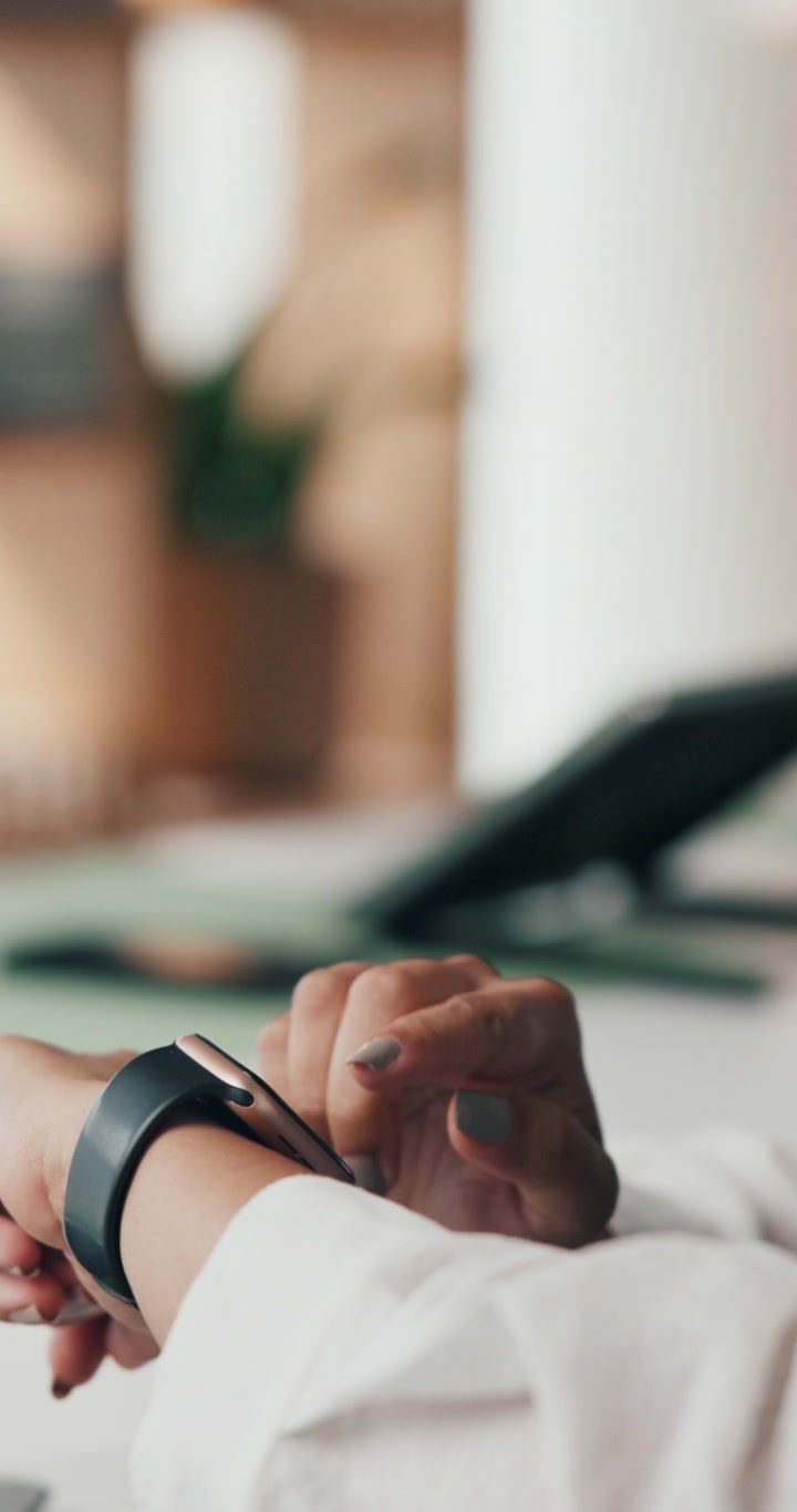 Person Using Smartwatch in Office Setting