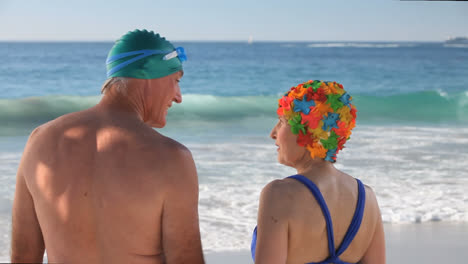 elderly couple running to the sea