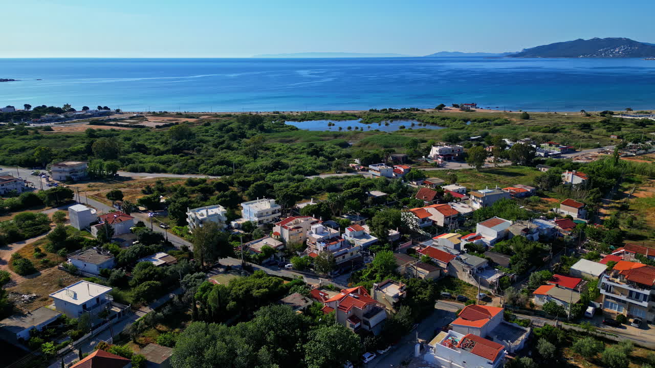 pueblo griego y paisaje oceánico de fondo - toma aérea de un avión no tripulado