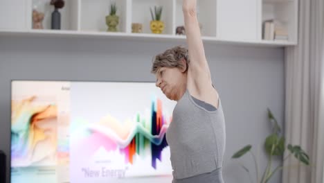 senior woman doing stretching exercises at home
