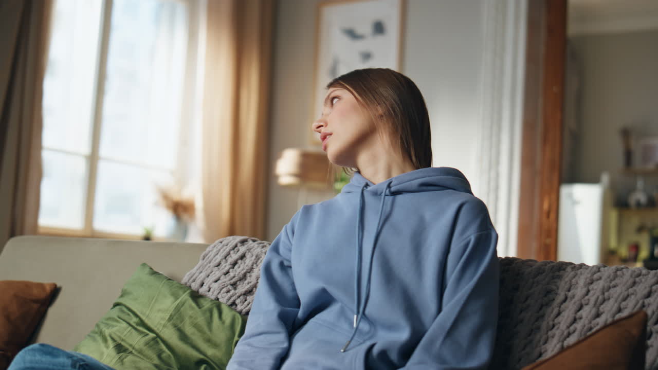 Woman playing video games on couch