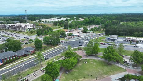 traffic on highway junction with gas station and apartment housing area in american town