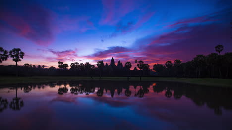 angkor wat reflection with vivid blue purple colours . iconic symbolic temple, siem reap, cambodia. time lapse.