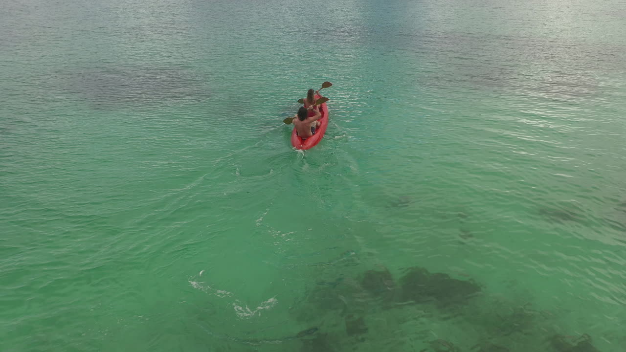 Couple Kayaking in Turquoise Water