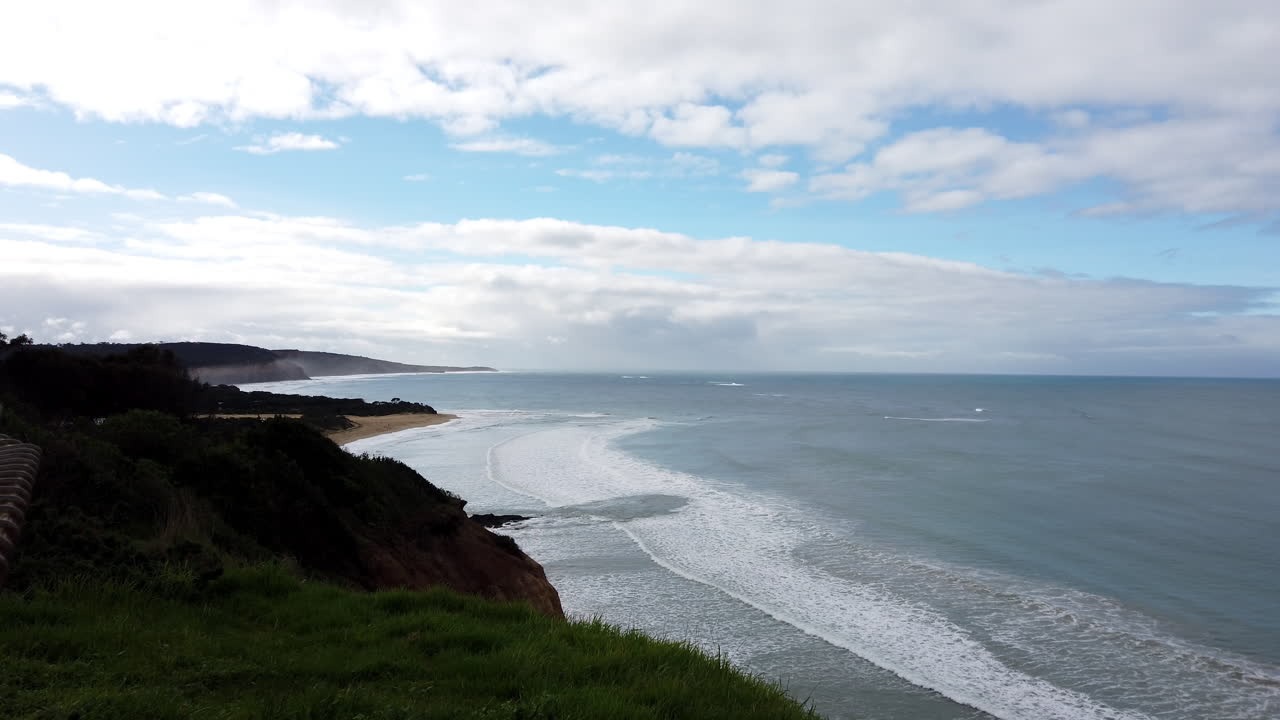 Stunning coastal scenery in Australia with long waves breaking on the shore, slow
