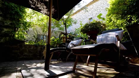 Beautiful-garden-terrace-with-2-Loungers-and-a-parasol-during-sunset