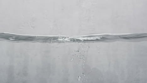 video of beauty product bottle falling into water with copy space on white background