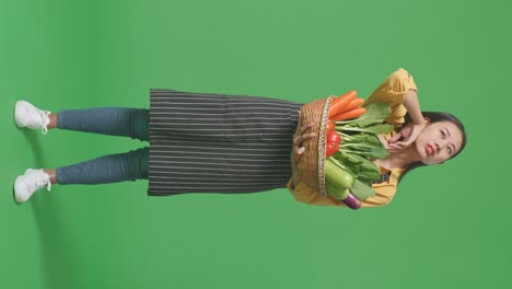 woman holding a basket of vegetables