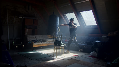 man working out in a home gym attic