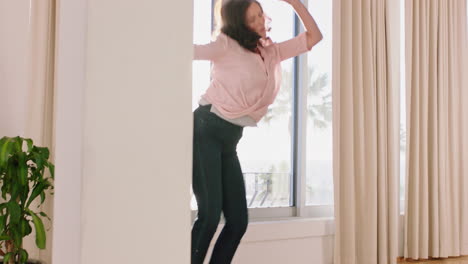 happy-woman-dancing-in-hotel-room-having-fun-enjoying-successful-travel-vacation-healthy-middle-aged-female-celebrating-retirement-at-sunrise