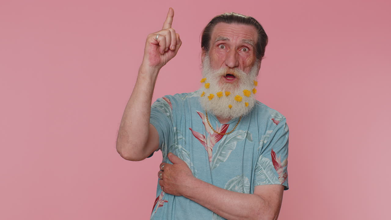 Inspired senior man pointing finger up, showing Eureka gesture, solution, idea, inspiration, answer