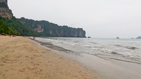 peaceful beach with waves and distant cliffs