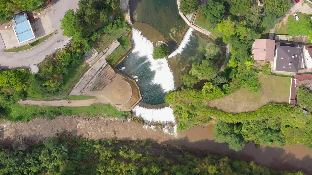 Panorama of Jajce Waterfall in Bosnia and Herzegovina with Pliva River below, Aerial top view up move