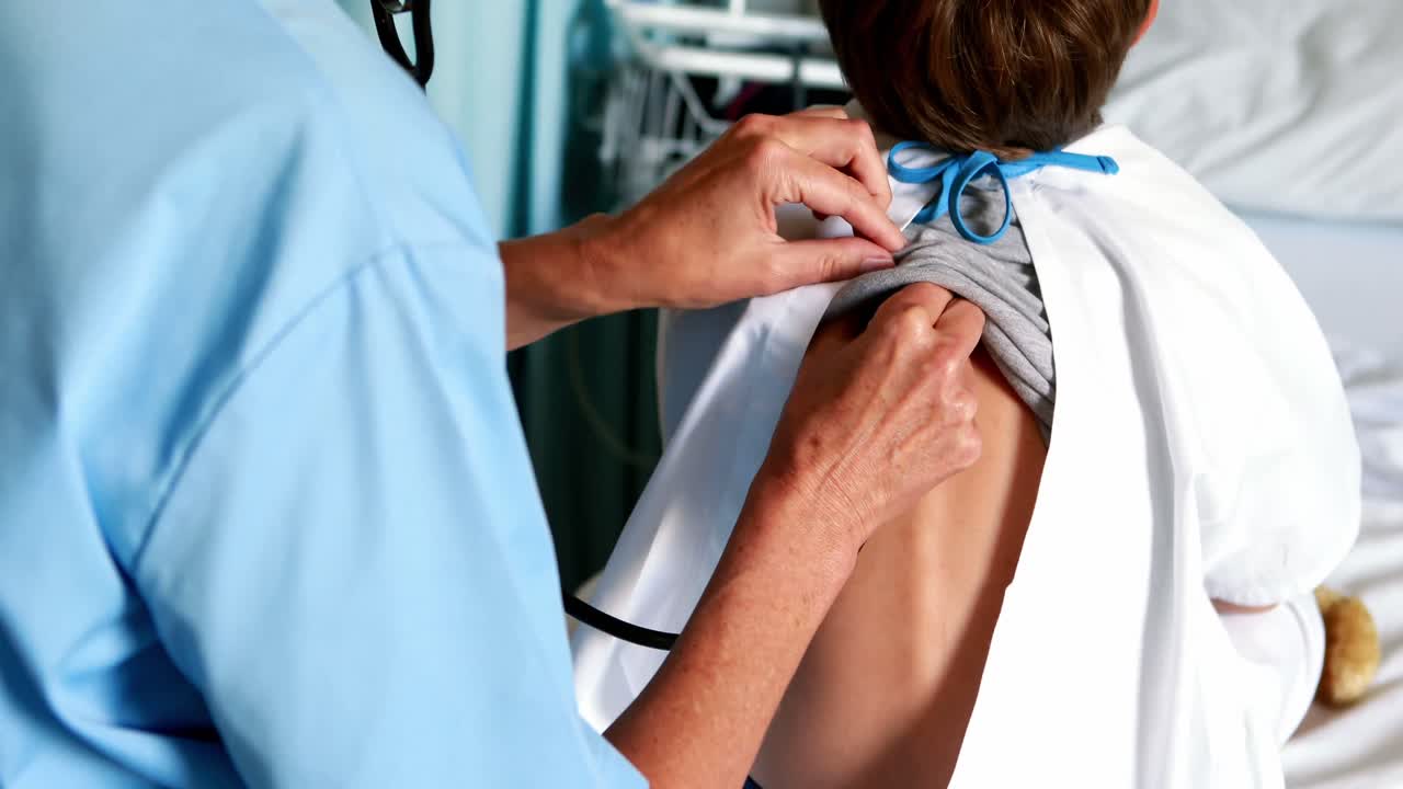 Female doctor examining patient with stethoscope