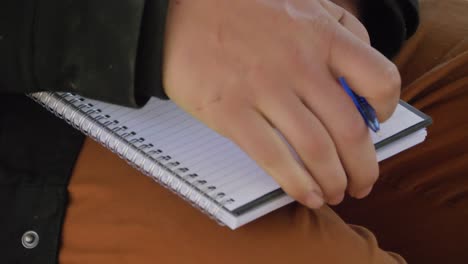 man taking down notes while listening to the discussion - manhood camp in mount byron, queensland - close up