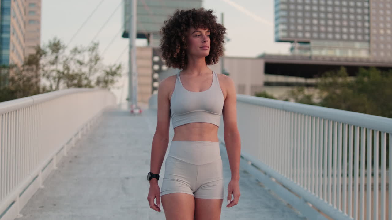 Sporty Woman Walks City Bridge