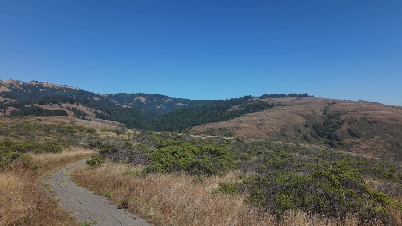 The coastline arcs in and out beneath the drone’s slow movement, showing off the curves of the rugged landscape