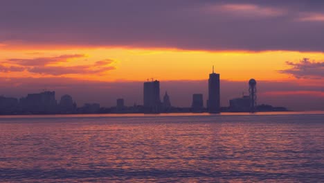 sea and sunset on the background of resort town. batumi in georgia.