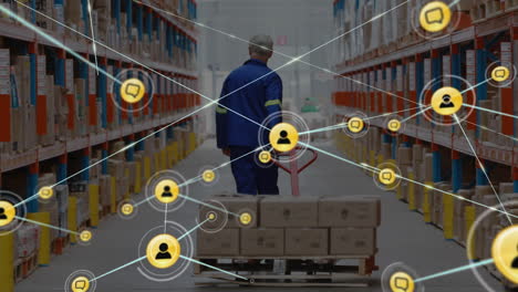 network of profile icons against rear view of male senior worker pulling a pallet at warehouse