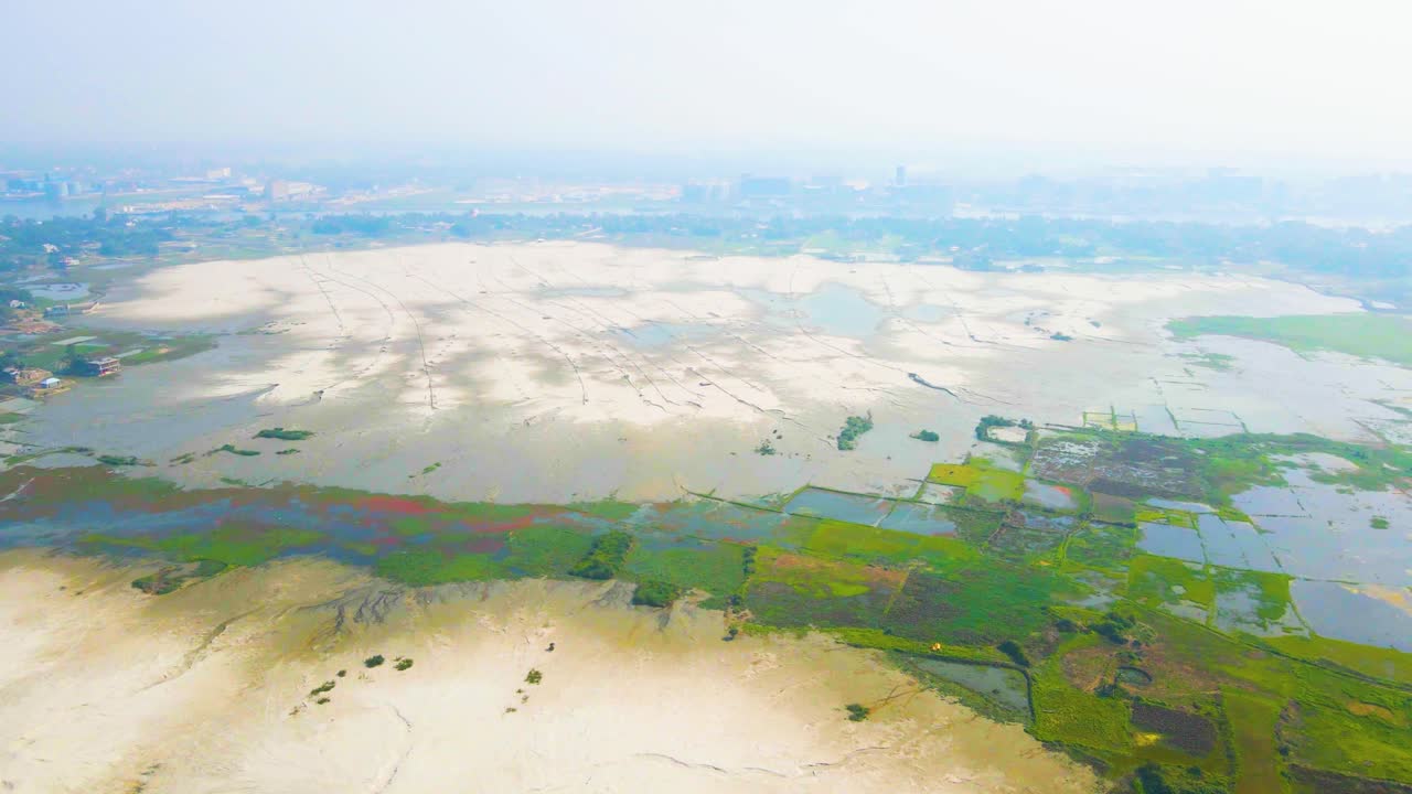 Green and vivid farmland in wetland in high angle drone view