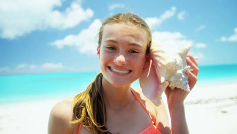 portrait of teenager on beach with conch shell