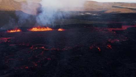 Incredible-active-lava-field-with-fissure-volcano-in-remote-nordic-valley,-aerial