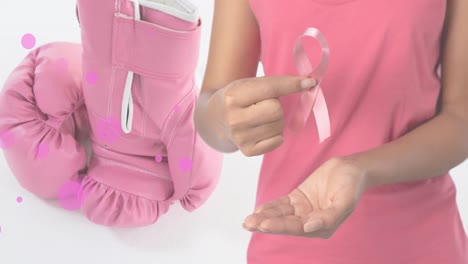 Animation-of-breast-cancer-awareness-text-over-caucasian-woman-and-boxing-gloves