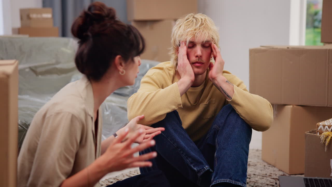Young Couple Stressed and Arguing While Moving into New Home