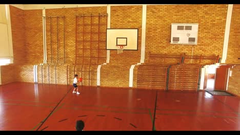 boys playing basketball in court