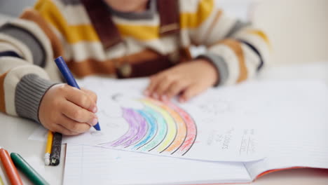 child coloring a rainbow