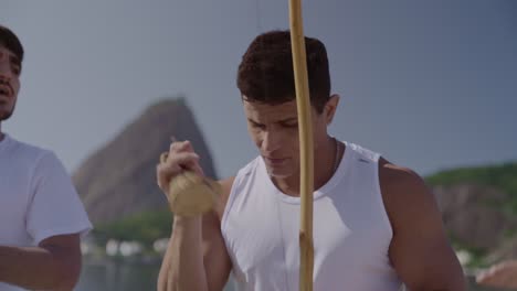 capoeira musicians playing berimbau instruments outdoors