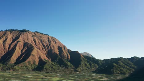 pergasingan hill on perfect sunny day with clear blue sky in lombok, aerial