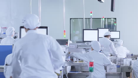 innovation biopharmaceutical manufacturing facility, researchers in sterile protective suits develop new drugs in pharmacy factory lab interior scientists work, check container bottles production line