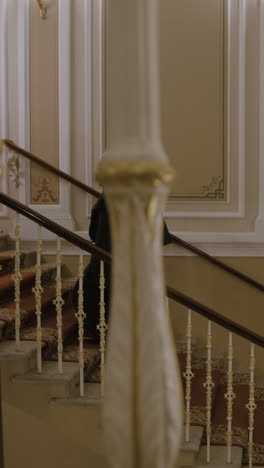 elegant staircase with formal attendees