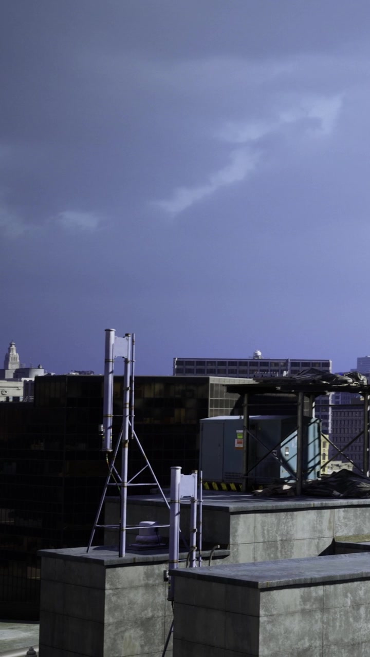 Stormy night sky over city rooftops with rooftop equipment and lights