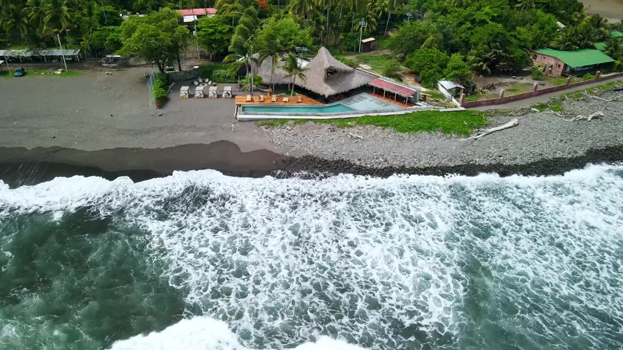 BEACH BUNGALOW ON DARK ROCK SAND