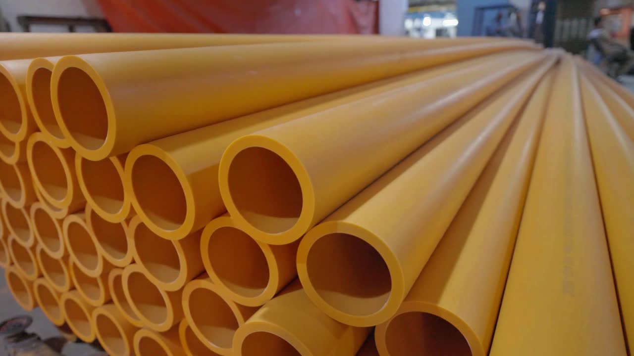 Stack of Yellow Plastic Pipes