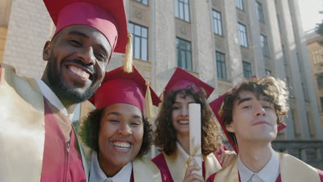 group of diverse graduates celebrating graduation
