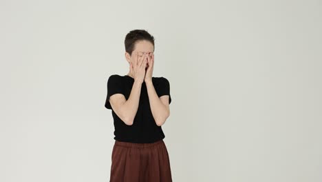 Woman with short hair yawning and rubbing eyes