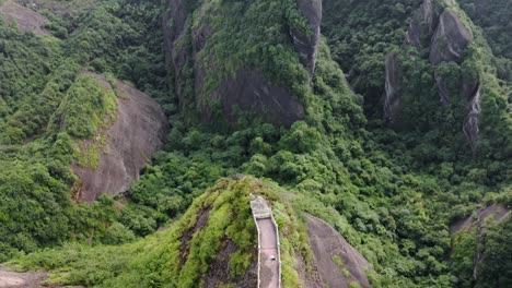 aerial: bajiao shan mountain viewpoint, hiker on chinese karst mountains