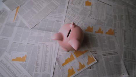 digital composition of colorful thunder storm effect against piggy bank falling on documents