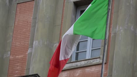 4k. italian flag waving in the wind, located in piazza dante, naples