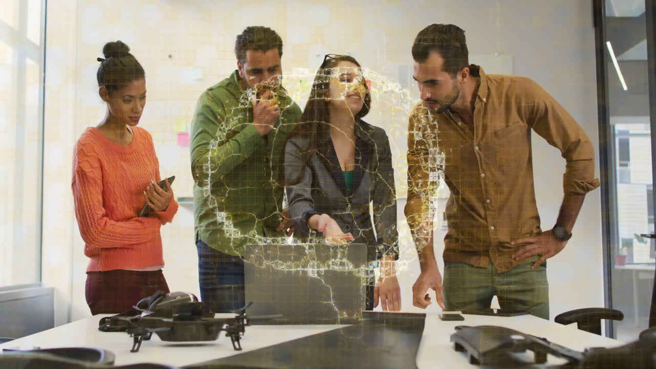 Collaborating on animation project, diverse team using technology in school setting