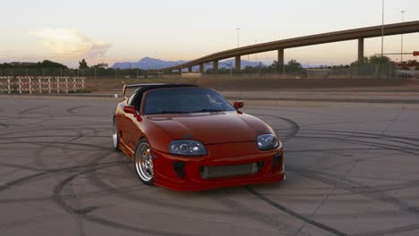 a parked cinematic red toyota supra