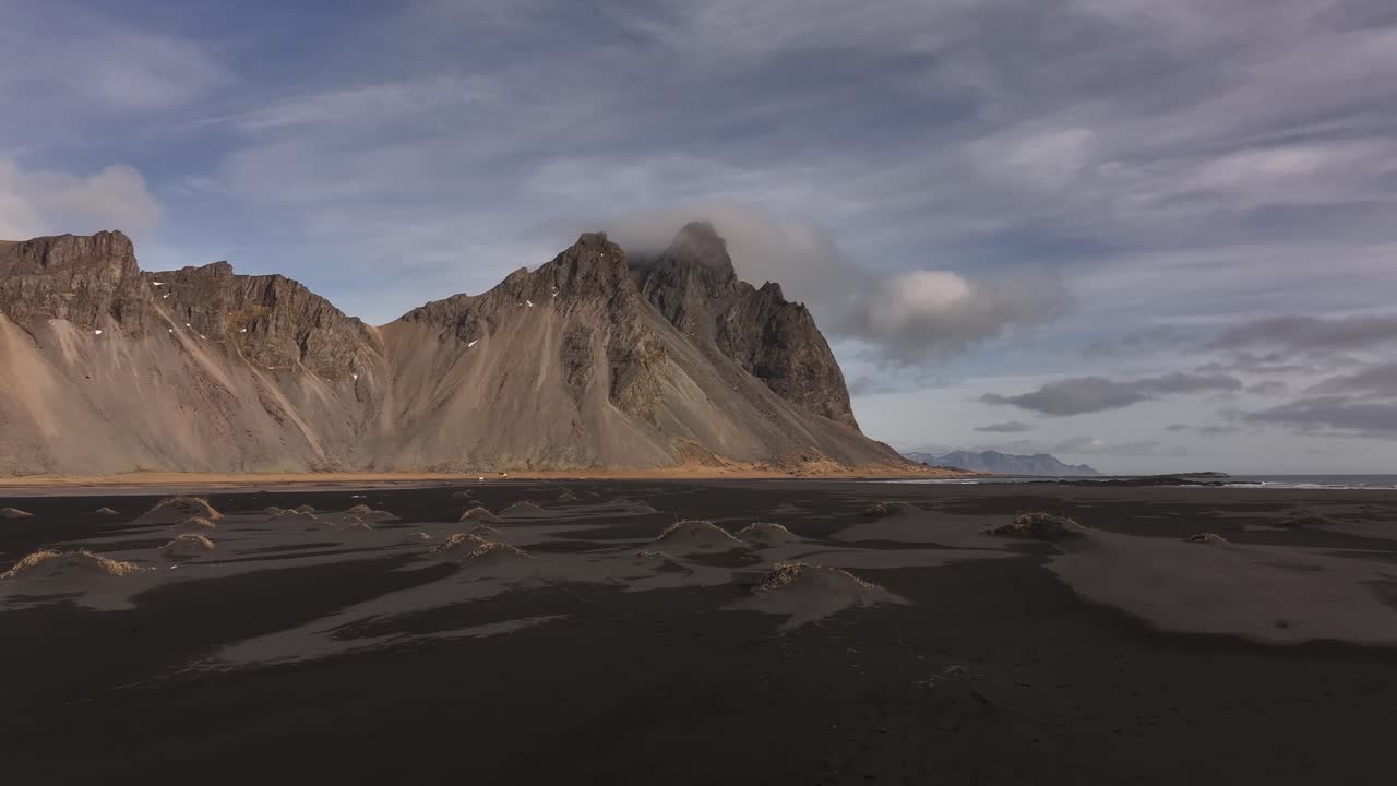 Majestic Vestrahorn mountain at Stokksnes with black sand dunes and cloudy sky
