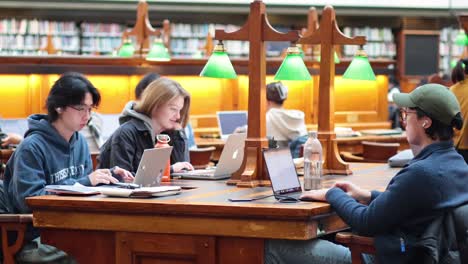 students studying together at library table