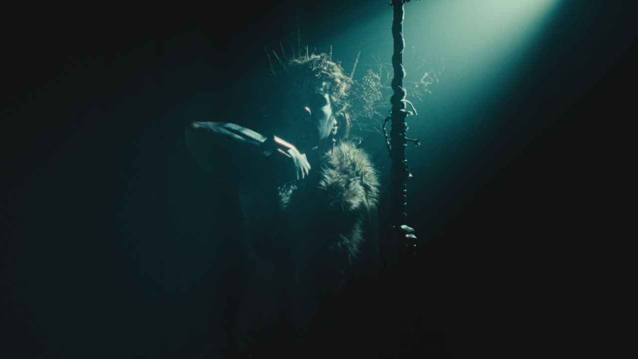 The witch makes a gesture of cutting her throat