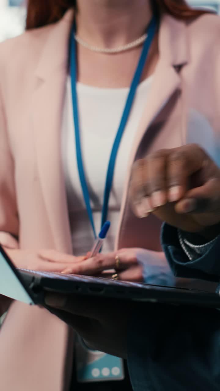 Vertical video Engineering team solving tasks in server farm using laptop