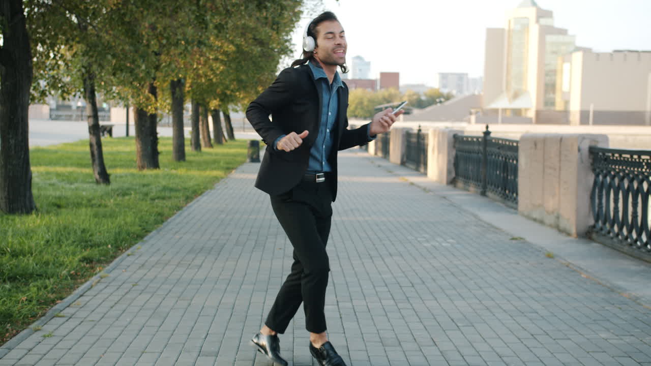 Man Dancing in the Park with Headphones