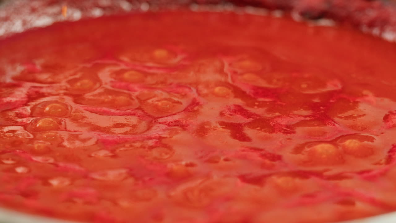 Chicken in tomato sauce is boiling on a frying pan with spices. Cooking tomato sauce curry with chicken fillet. Traditional Italian Mexican Asian dish. High quality studio shot for cafe, restaurant close up.